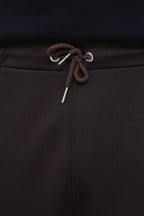Premium men's pleated trousers by theseventhstitch, showcasing tailored fit and classic pleats in a neutral fabric.
