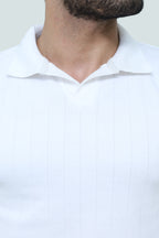 White cable-knit polo shirt from theseventhstitch, featuring a classic collar and textured knit fabric.